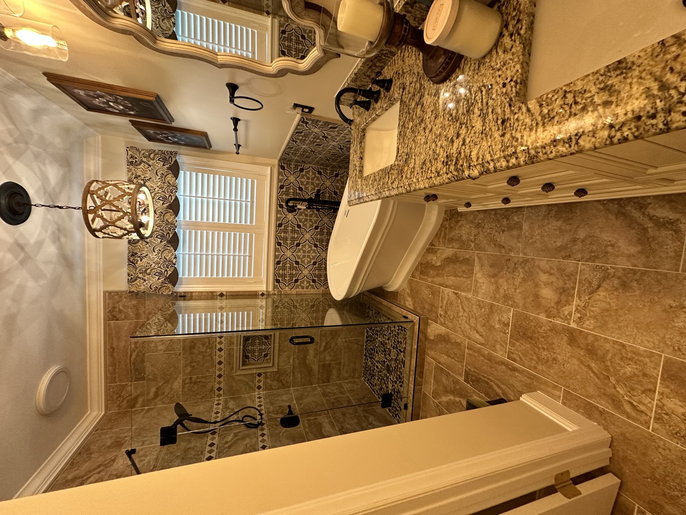 Traditional master bathroom with freestanding tub, granite vanity, and tiled shower