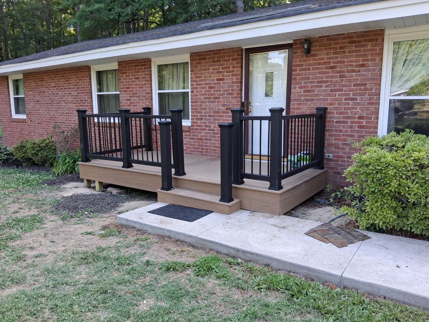Gray composite deck with white vinyl railing and outdoor seating