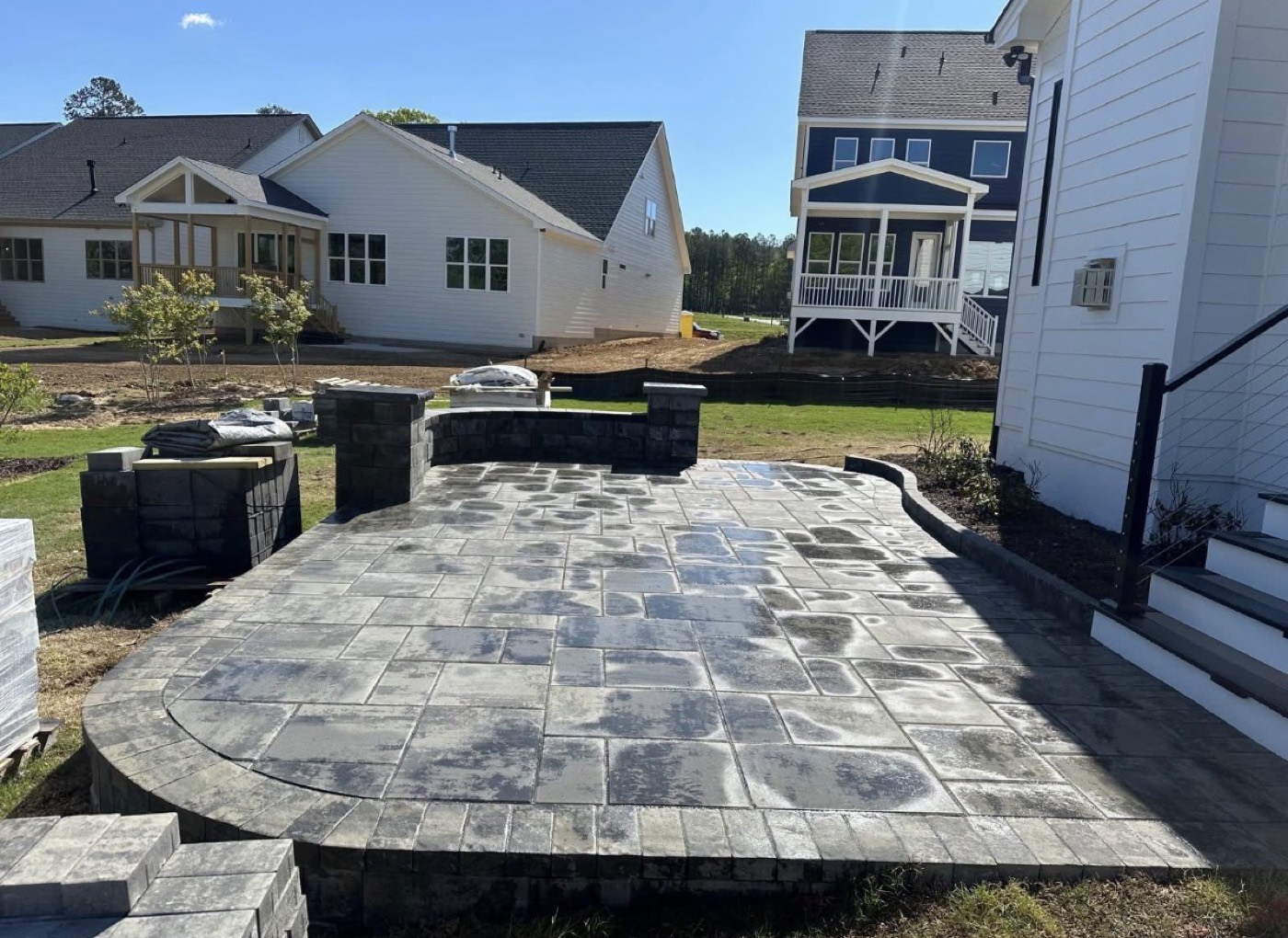Large stone paver patio with seat walls and columns